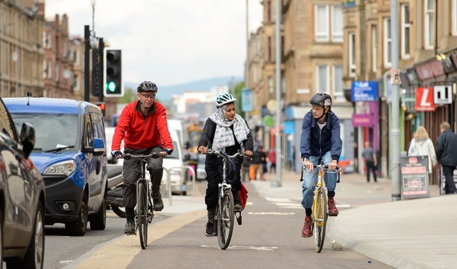 Three cyclists travel alongside each other on the South City Way in Glasgow