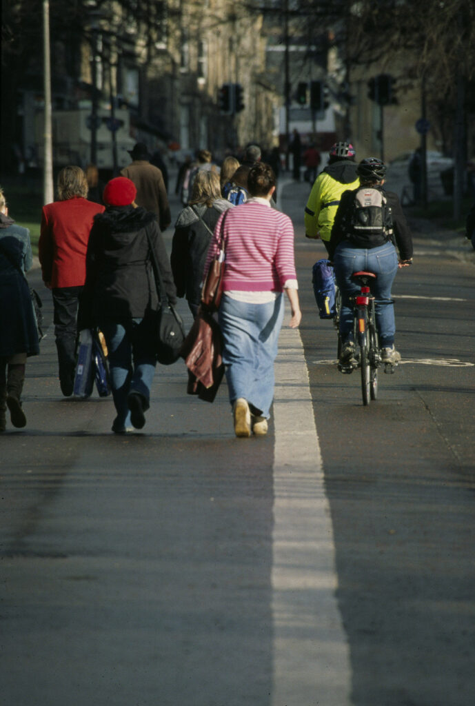 People travelling actively on Middle Meadow Walk in Edinburgh