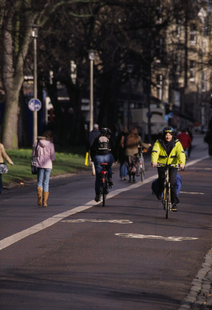 People travelling actively on Middle Meadow Walk in Edinburgh